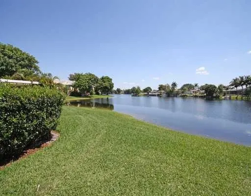 a view of a lake with houses in the back