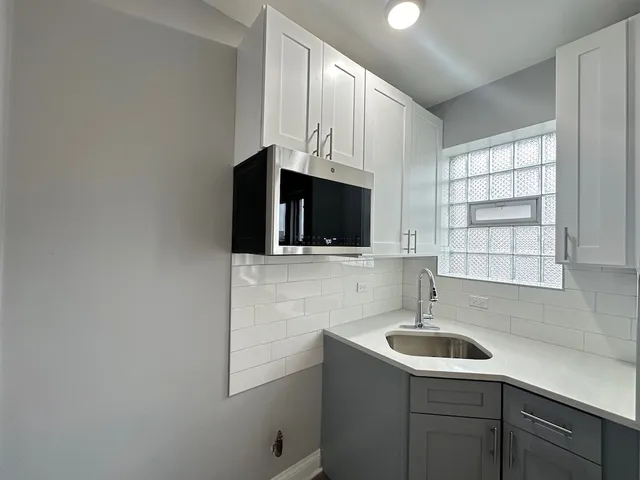 a kitchen with a sink and cabinets