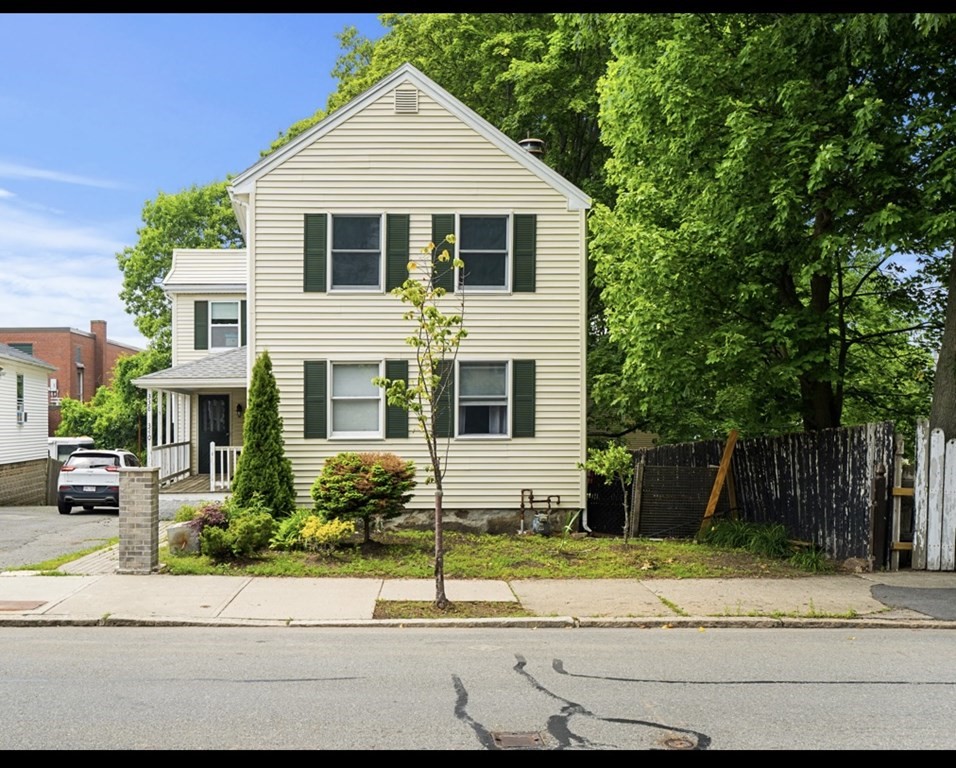 338 Cabot Street Beverly, MA 01915 - Photo 2 of 14 a front view of a house with a yard