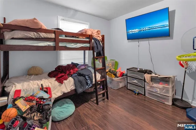 a bedroom with furniture and a wooden floor