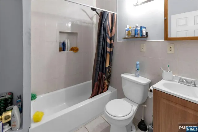 a white toilet sitting next to a bathroom sink and tub