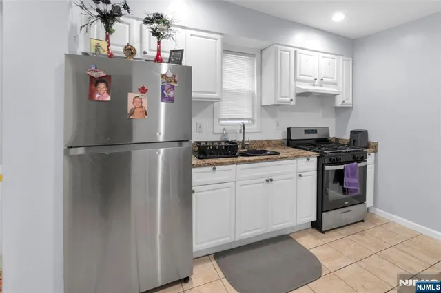 a white refrigerator freezer sitting inside of a kitchen