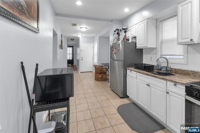 a kitchen with a sink cabinets and appliances