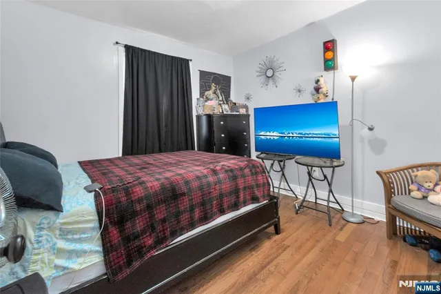 a spacious bedroom with a bed and a dresser