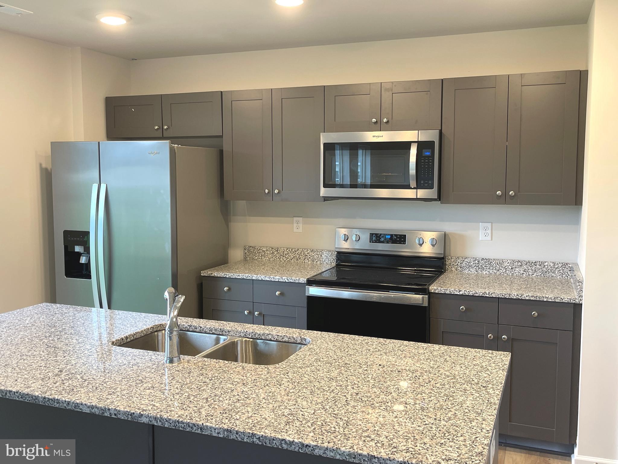 732 R Wilson Loop Georgetown, DE 19947 - Photo 6 of 41 a kitchen with stainless steel appliances granite countertop a sink stove and refrigerator