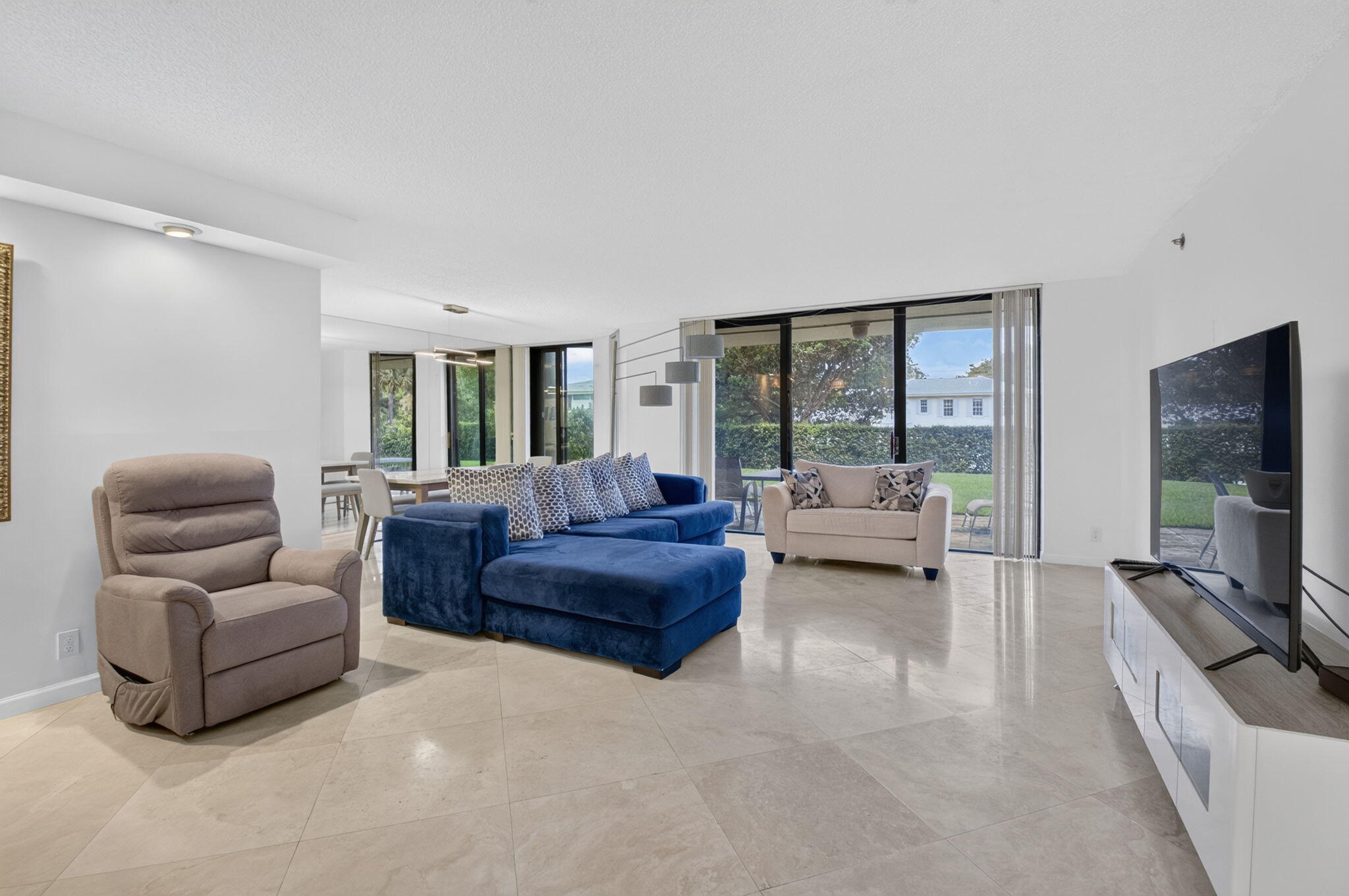 1401 South Ocean Boulevard, Unit 1060 Boca Raton, FL 33432 - Photo 4 of 46 a living room with furniture and a large window