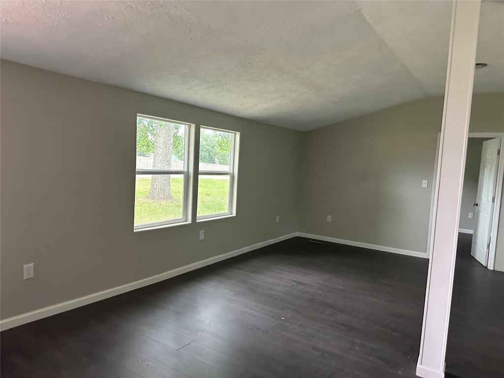 11330 Lakeview Road Brenham, TX 77833 - Photo 6 of 14 an empty room with wooden floor and windows