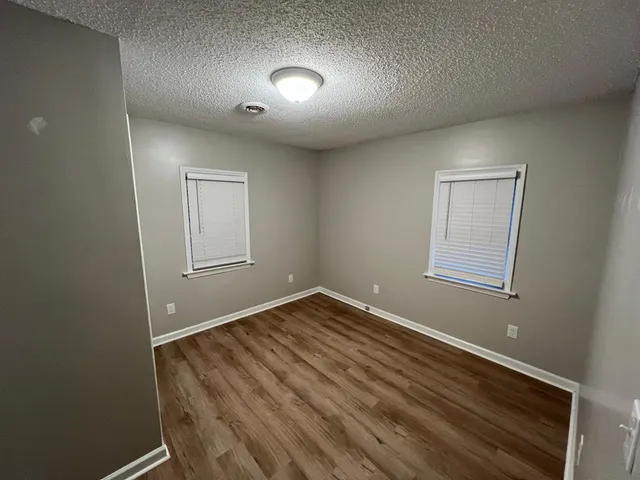 a view of room with window and hardwood floor