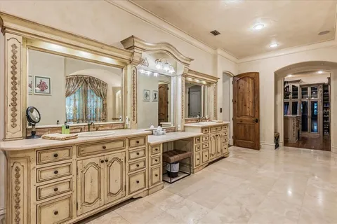 a view of a hallway with cabinet and mirrors
