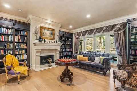 a living room with furniture a flat screen tv and kitchen view