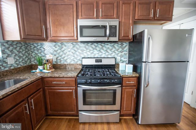 a kitchen with a sink stove and microwave