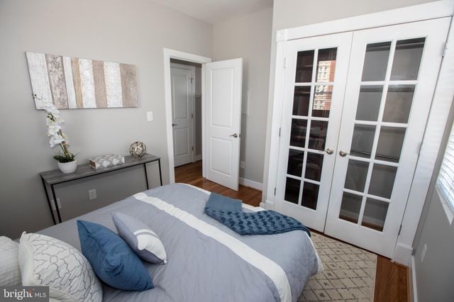 a bed sitting in a bedroom next to a window
