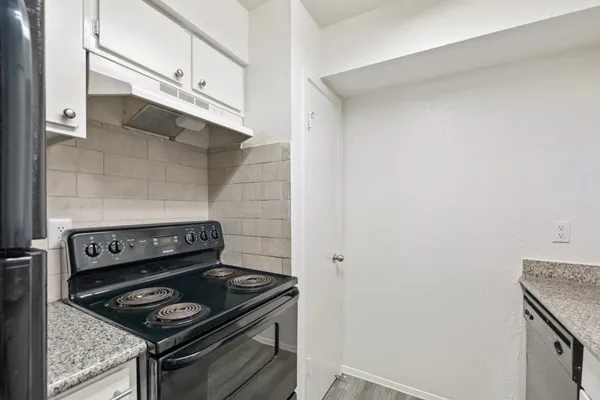a stove top oven sitting inside of a kitchen