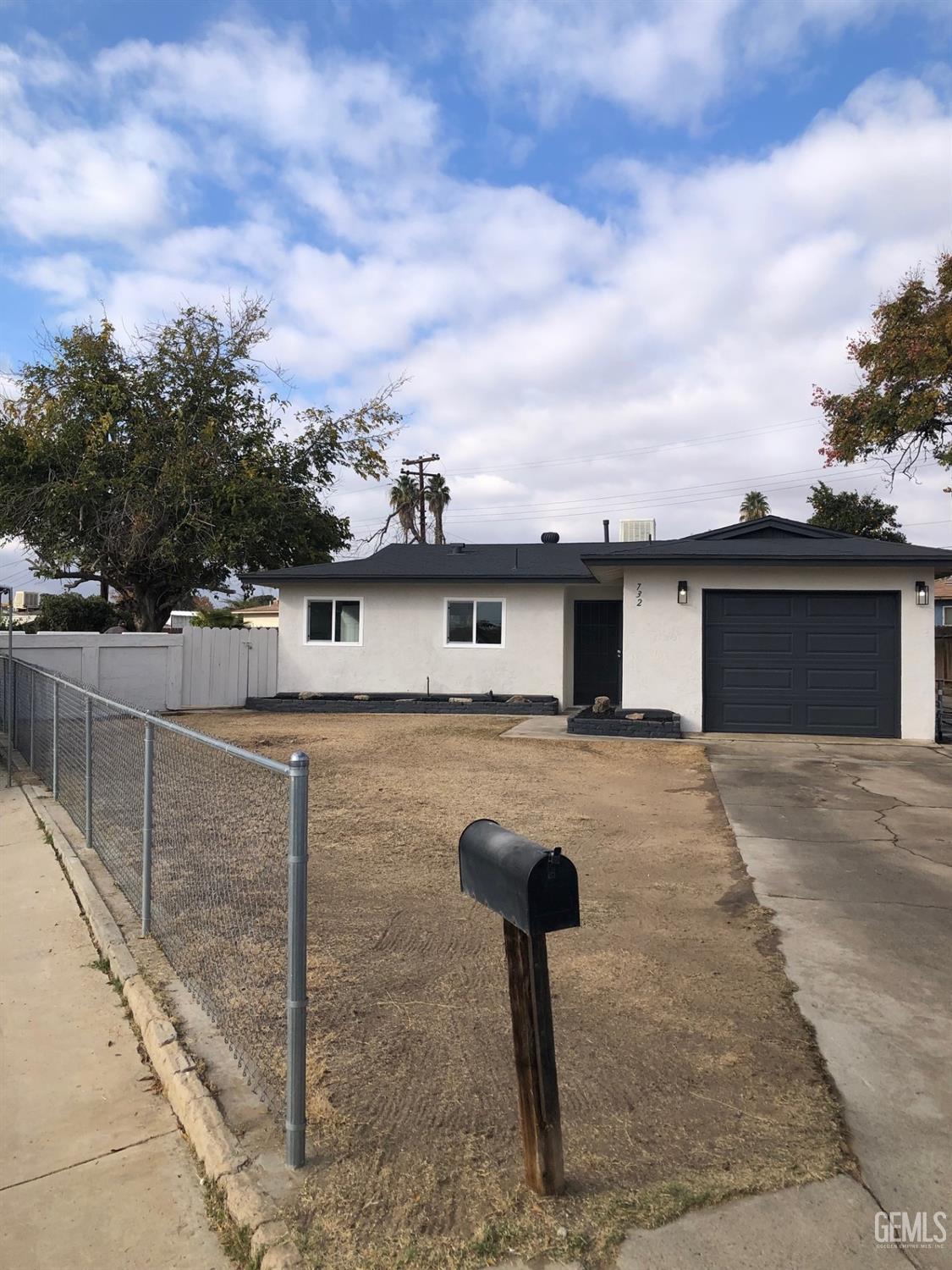 Undisclosed Address Bakersfield, CA 93306 - Photo 17 of 19 a front view of a house with garden