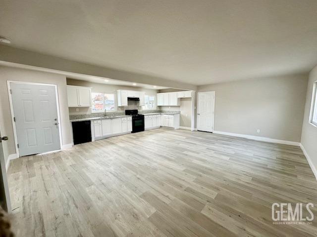Undisclosed Address Bakersfield, CA 93306 - Photo 3 of 19 a big room with wooden floor and kitchen view