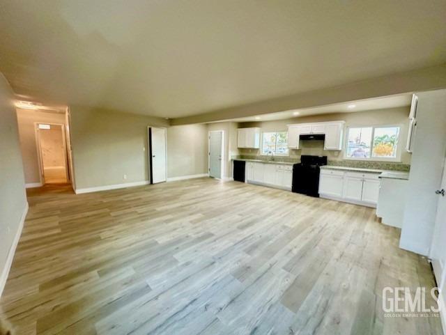 Undisclosed Address Bakersfield, CA 93306 - Photo 5 of 19 a view of a kitchen with granite countertop cabinets and wooden floor