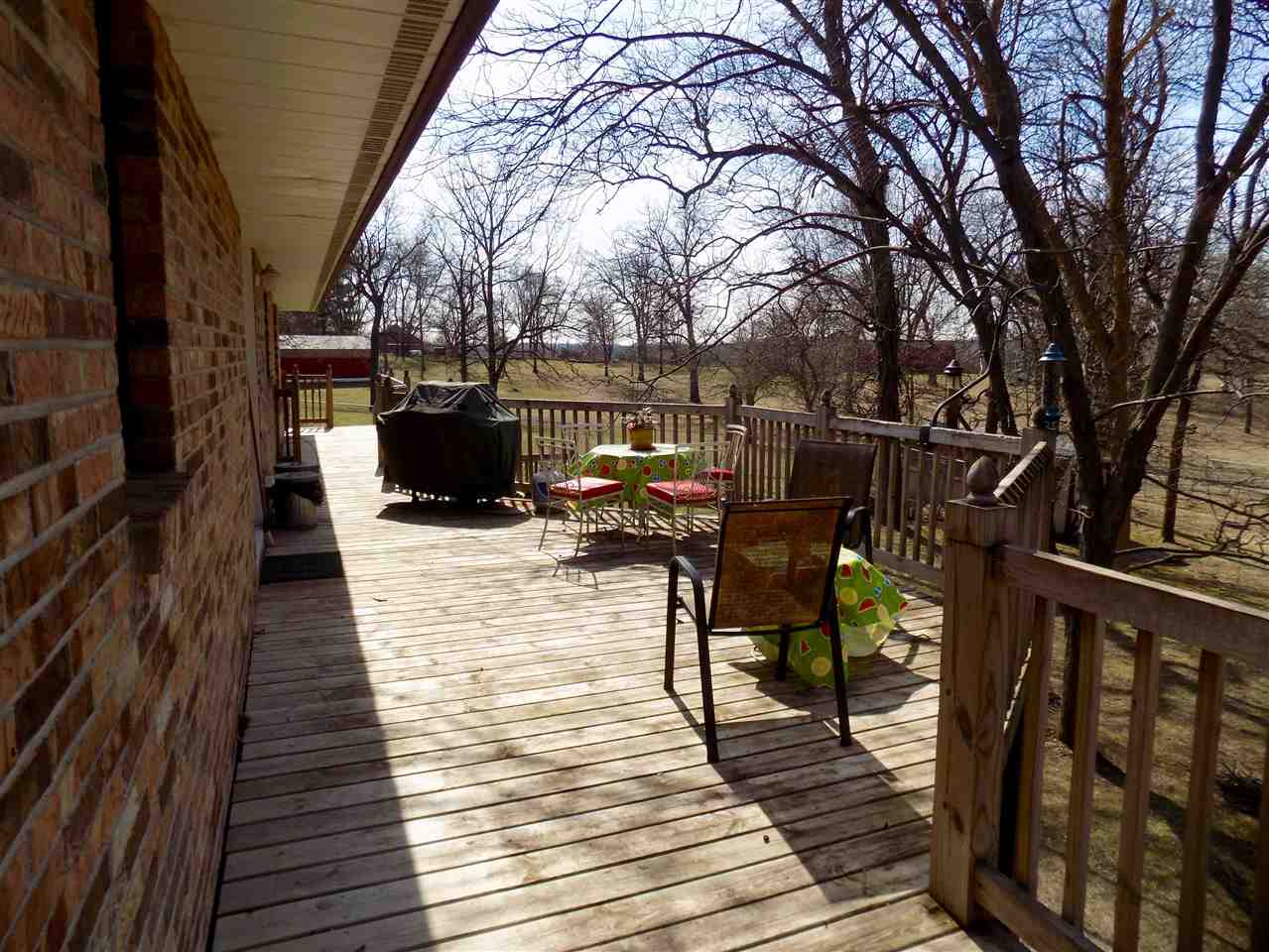 4401 Centerville Road Rockford, IL 61102 - Photo 14 of 23 a view of a patio with table and chairs with wooden floor and fence