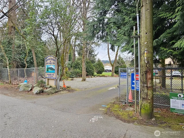 a view of road with card and parked