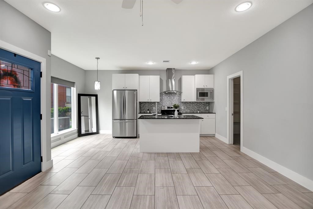 20 Evanston Street Houston, TX 77015 - Photo 2 of 31 a kitchen with stainless steel appliances a refrigerator and wooden floor