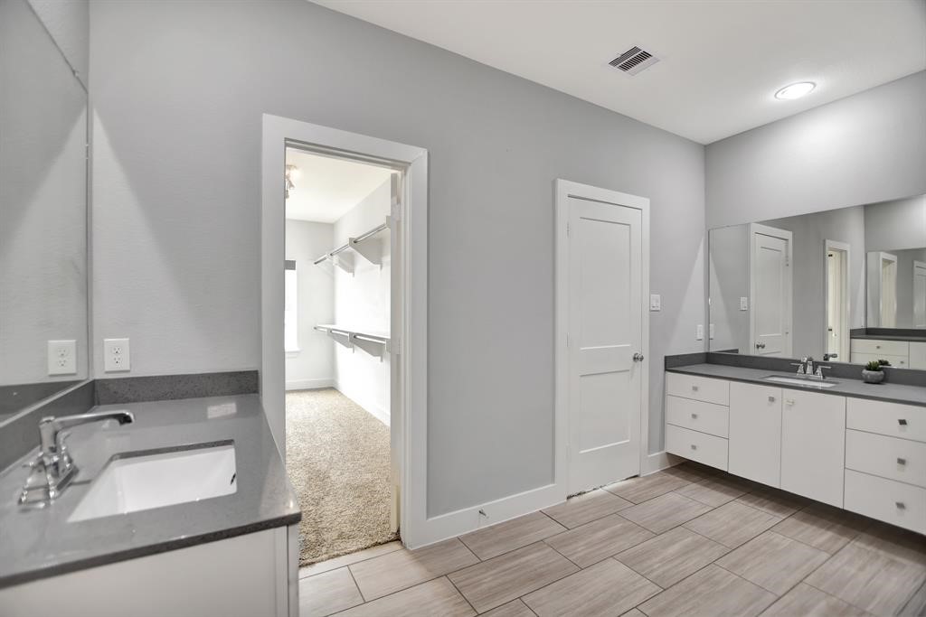 20 Evanston Street Houston, TX 77015 - Photo 22 of 31 a bathroom with a granite countertop sink and a mirror