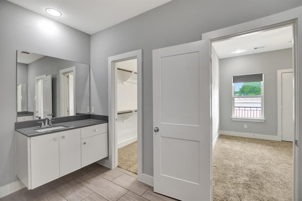 20 Evanston Street Houston, TX 77015 - Photo 25 of 31 a bathroom with a granite countertop sink and a mirror