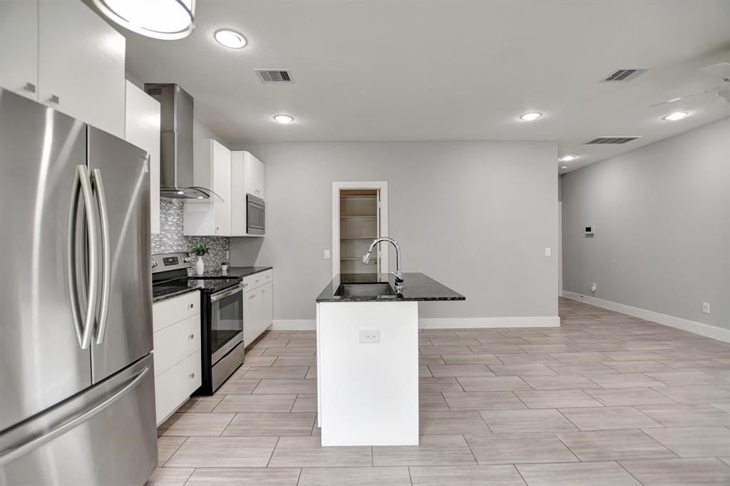 20 Evanston Street Houston, TX 77015 - Photo 6 of 31 a kitchen with stainless steel appliances granite countertop a refrigerator and a stove