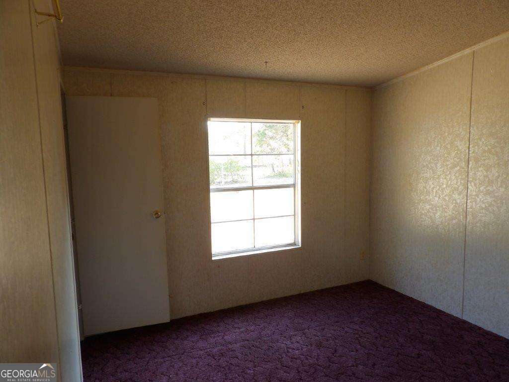 111 Sunnyside Drive Box Springs, GA 31801 - Photo 16 of 18 an empty room with a window