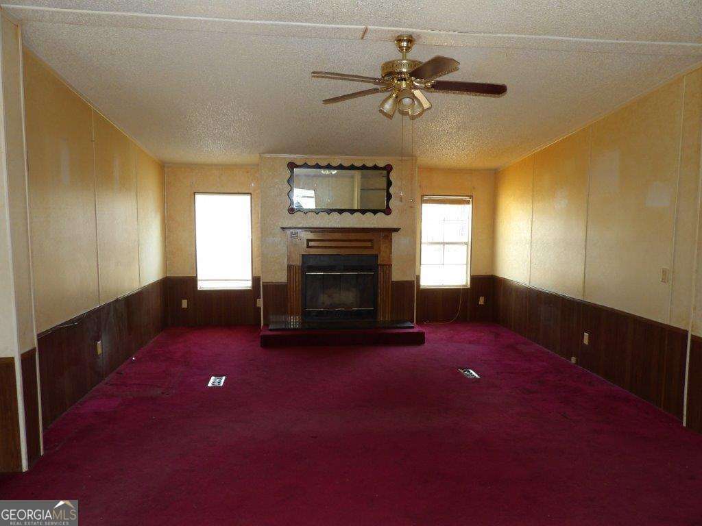 111 Sunnyside Drive Box Springs, GA 31801 - Photo 6 of 18 a view of empty room with a fireplace and window