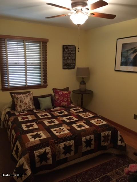17 Spring Road Adams, MA 01220 - Photo 18 of 37 a bedroom with a bed and a chandelier