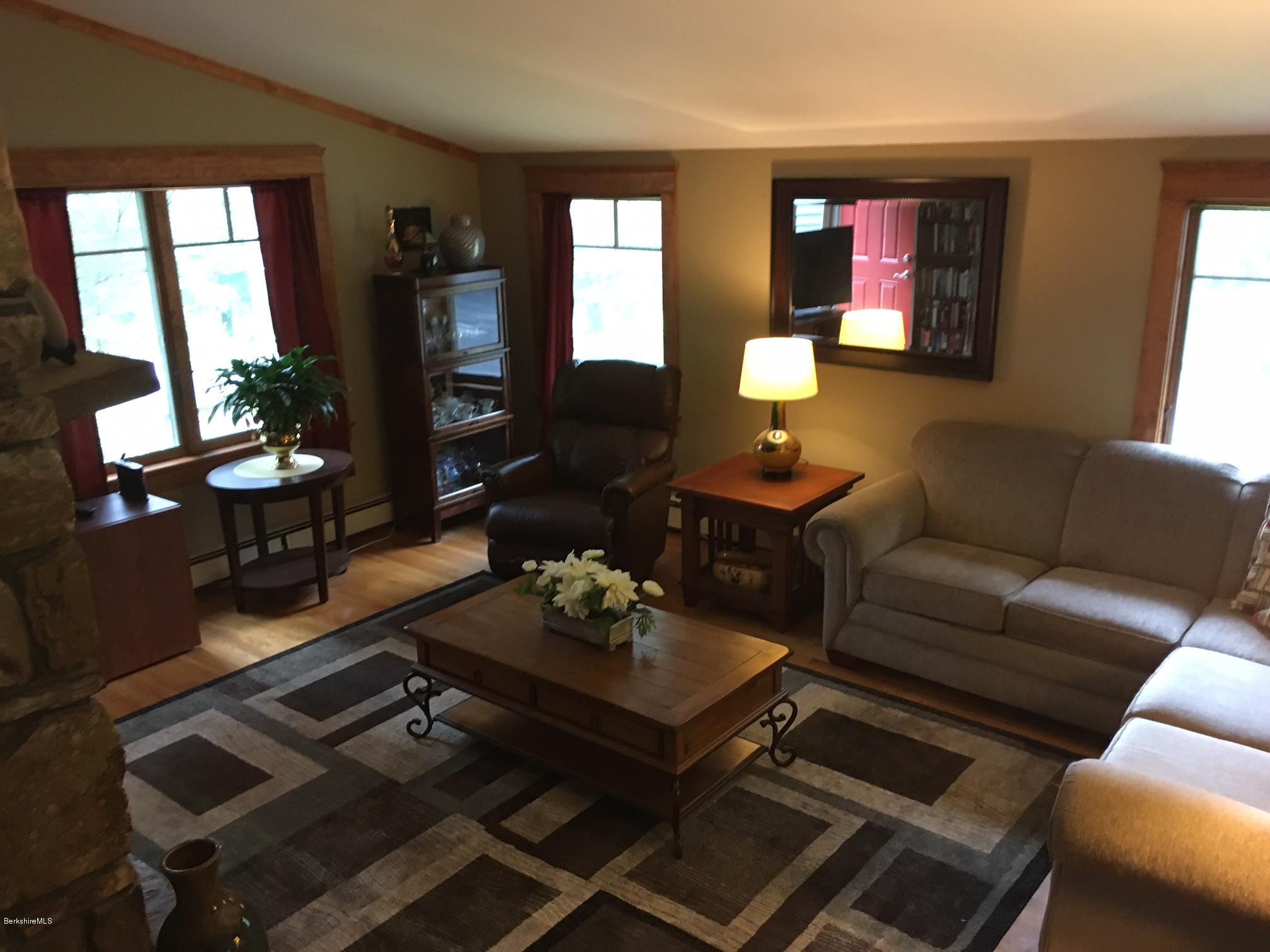 17 Spring Road Adams, MA 01220 - Photo 6 of 37 a living room with furniture fireplace and large windows