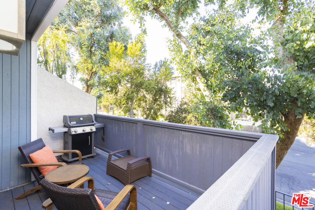 8176 Manitoba Street, Unit 4 Playa del Rey, CA 90293 - Photo 15 of 24 a backyard of a house with table and chairs
