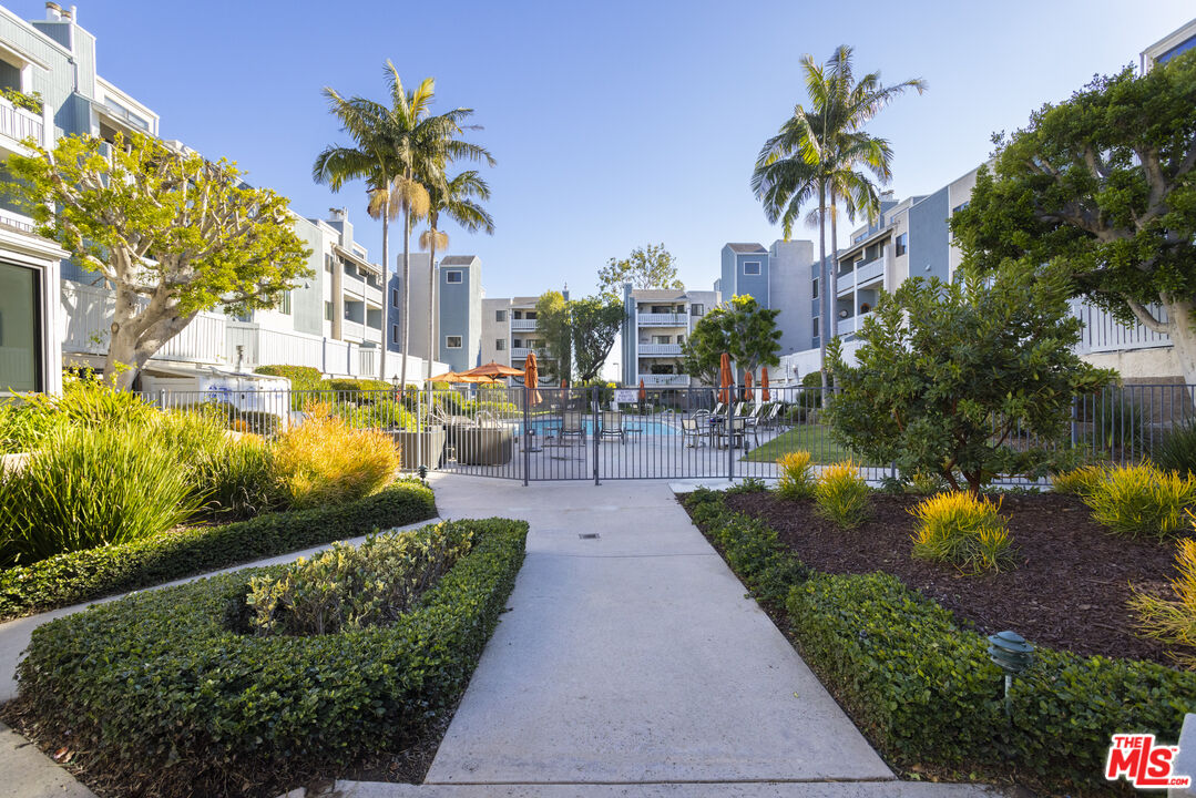 8176 Manitoba Street, Unit 4 Playa del Rey, CA 90293 - Photo 17 of 24 a view of a swimming pool with a garden