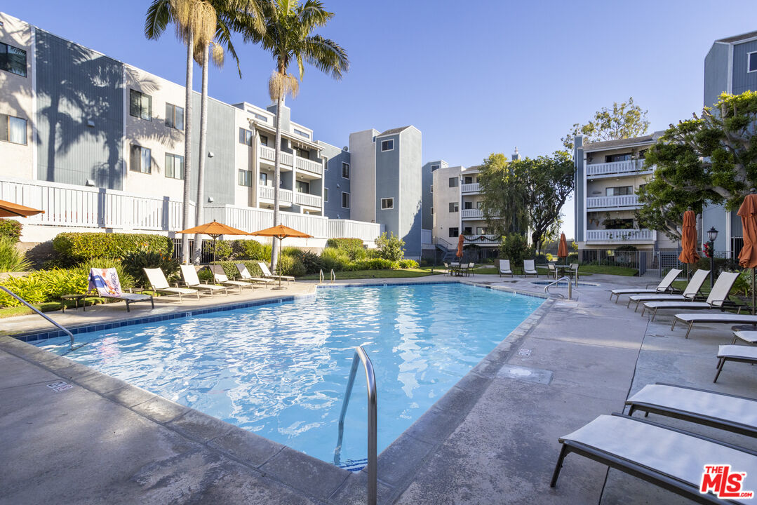 8176 Manitoba Street, Unit 4 Playa del Rey, CA 90293 - Photo 19 of 24 a view of a swimming pool with a lounge chairs
