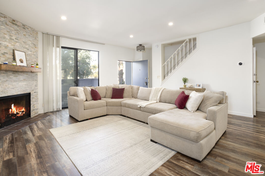 8176 Manitoba Street, Unit 4 Playa del Rey, CA 90293 - Photo 2 of 24 a living room with furniture and a fireplace