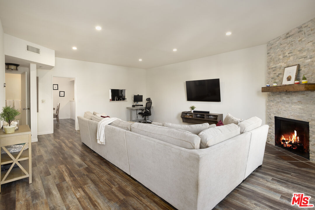 8176 Manitoba Street, Unit 4 Playa del Rey, CA 90293 - Photo 3 of 24 a living room with furniture a flat screen tv and a fireplace