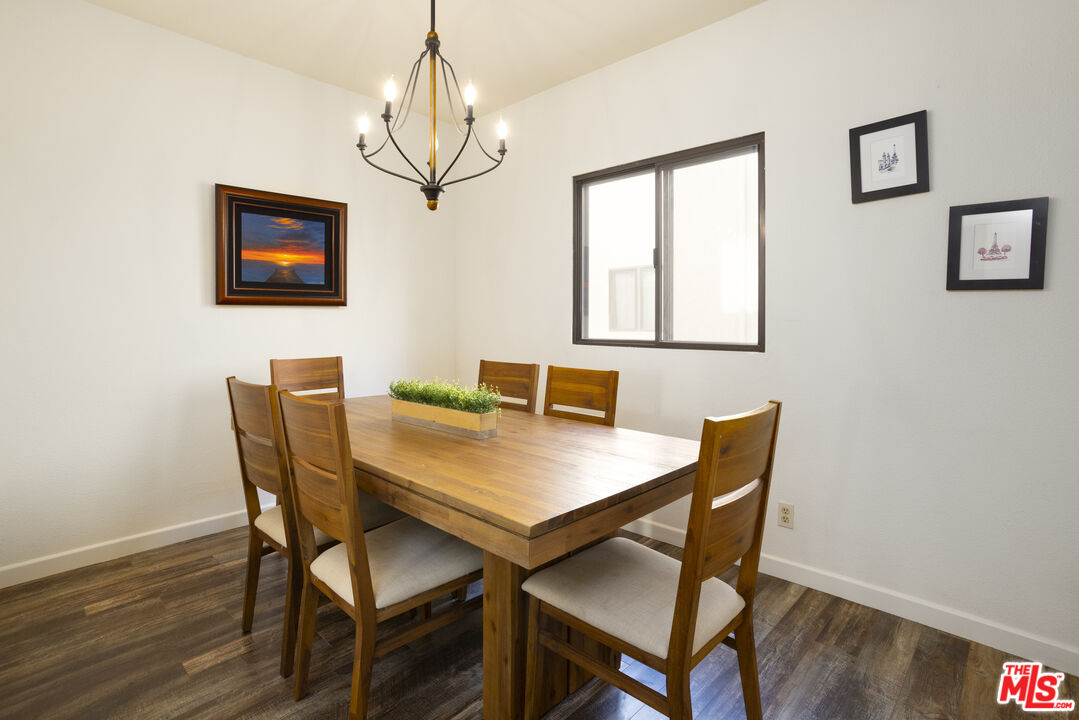 8176 Manitoba Street, Unit 4 Playa del Rey, CA 90293 - Photo 4 of 24 a view of a dining room with furniture wooden floor and a chandelier