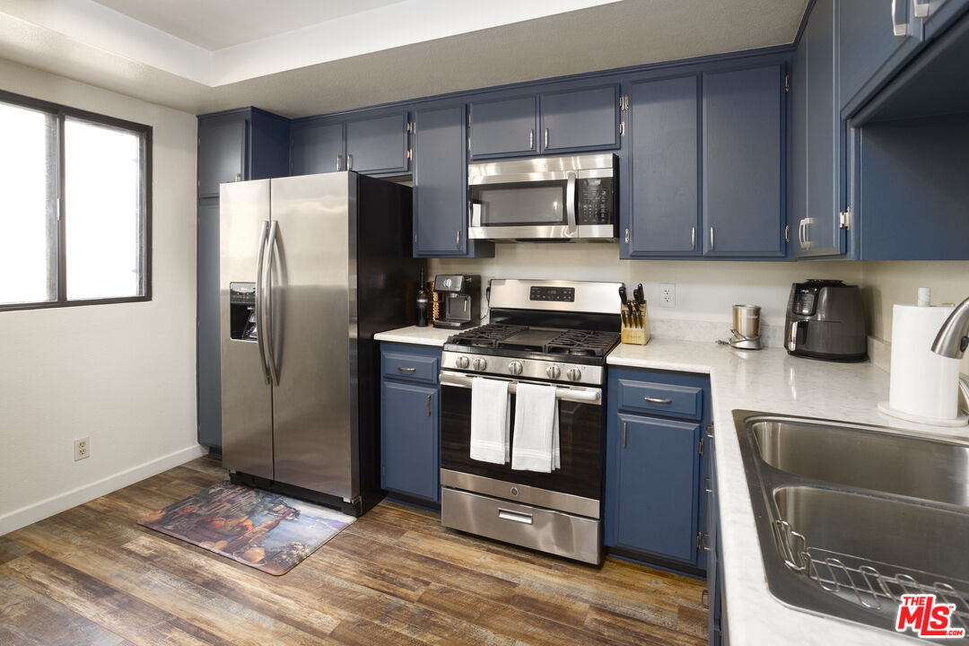8176 Manitoba Street, Unit 4 Playa del Rey, CA 90293 - Photo 5 of 24 a kitchen with stainless steel appliances granite countertop a refrigerator stove and microwave