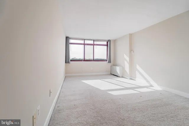 an empty room with a empty space and windows