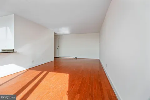 a view of a room with wooden floor and bench