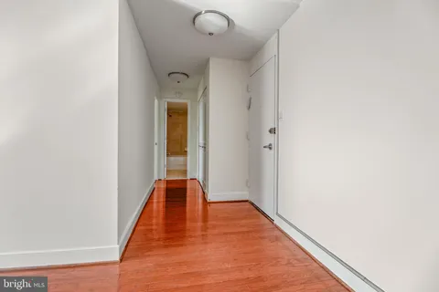 a view of a hallway with wooden floor