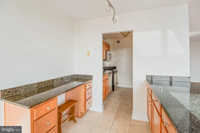 a kitchen with stainless steel appliances granite countertop a sink and dishwasher