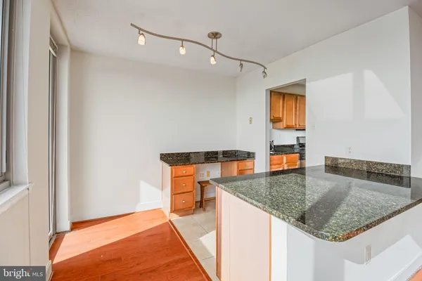 a kitchen with stainless steel appliances granite countertop a sink and a granite counter tops