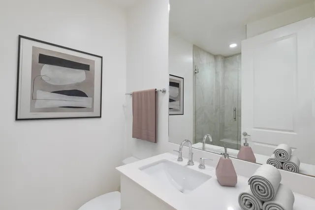 a bathroom with a sink mirror and vanity