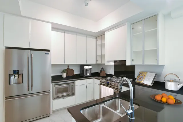 a kitchen with stainless steel appliances a stove a sink and a refrigerator