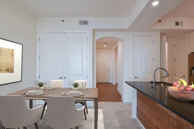 a room with a table chairs and a stove