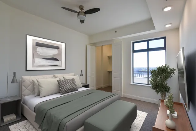 a bedroom with a bed and a window