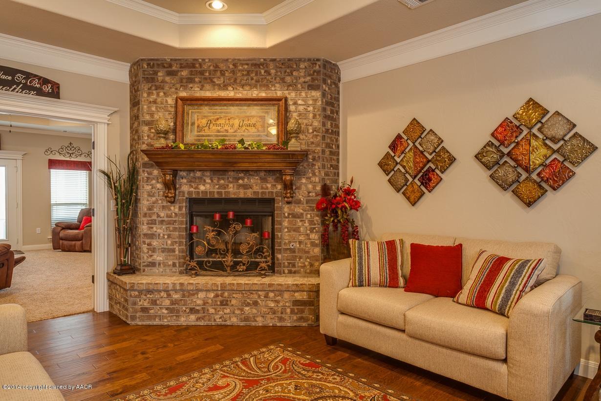 18500 Grasslands Road Bushland, TX 79124 - Photo 8 of 33 Living room fireplace and wood floor