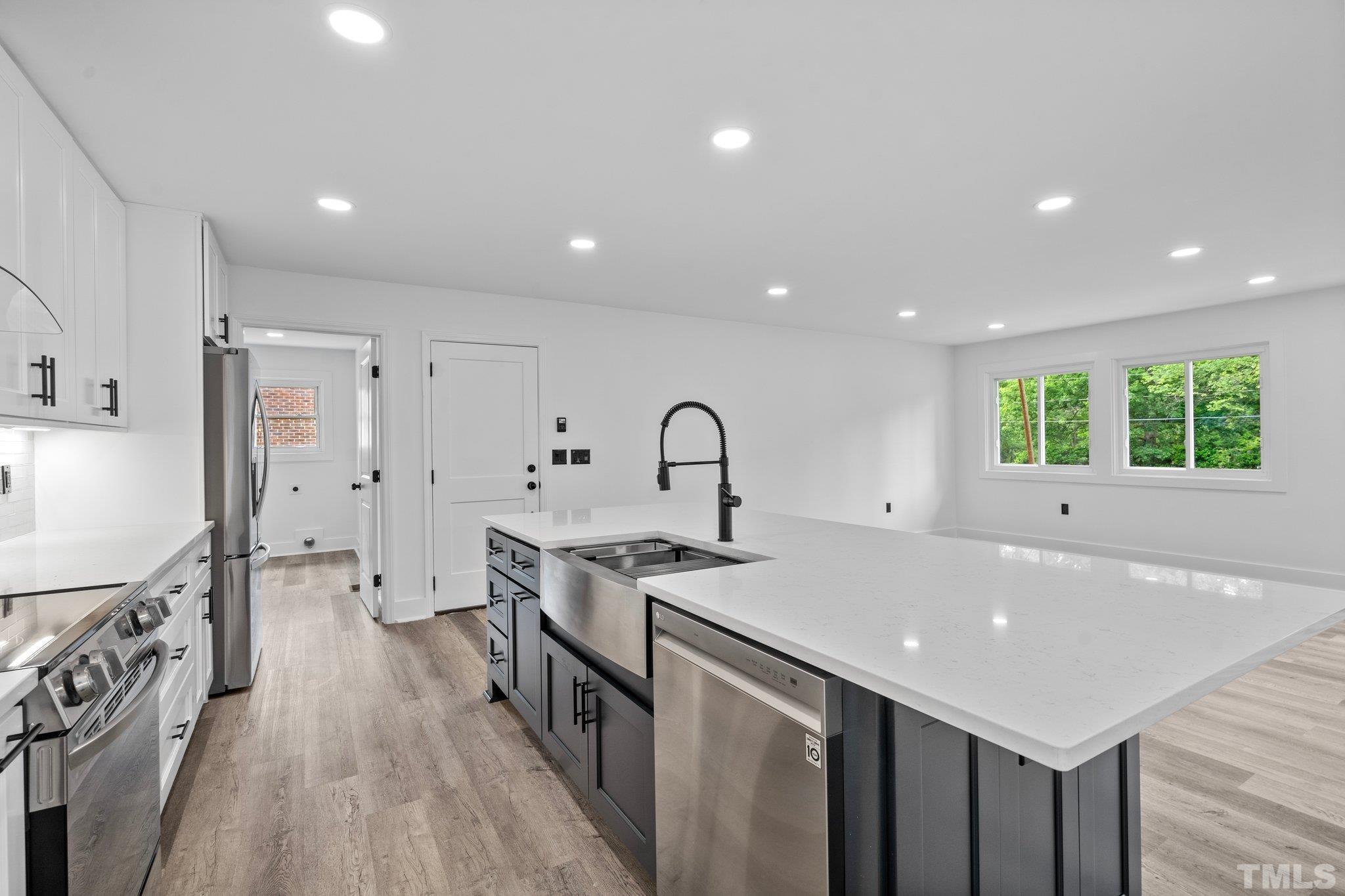 1102 Jerome Road Durham, NC 27713 - Photo 11 of 41 a kitchen with stainless steel appliances a sink stove and cabinets