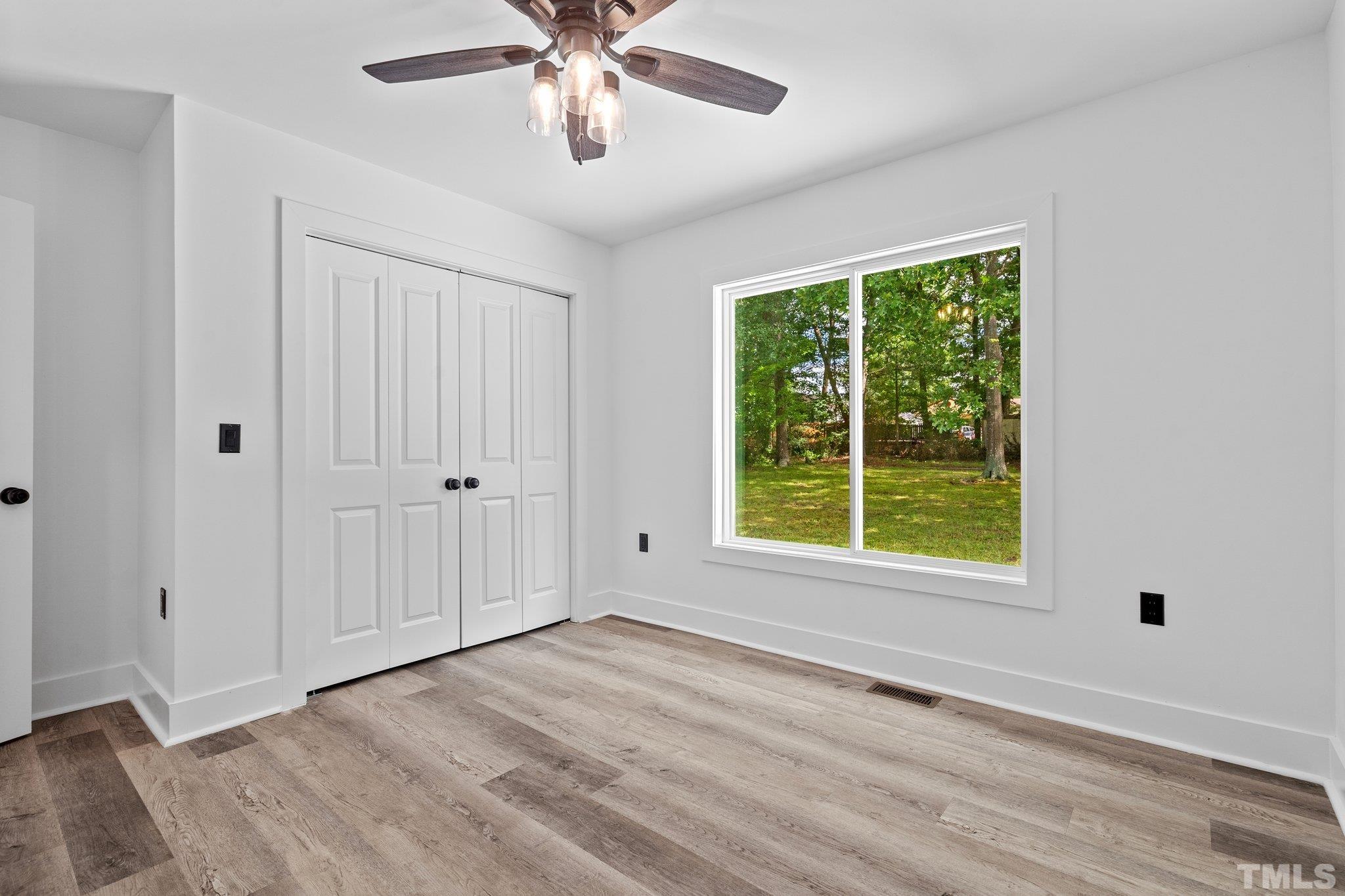 1102 Jerome Road Durham, NC 27713 - Photo 21 of 41 a view of an empty room with a window and wooden floor