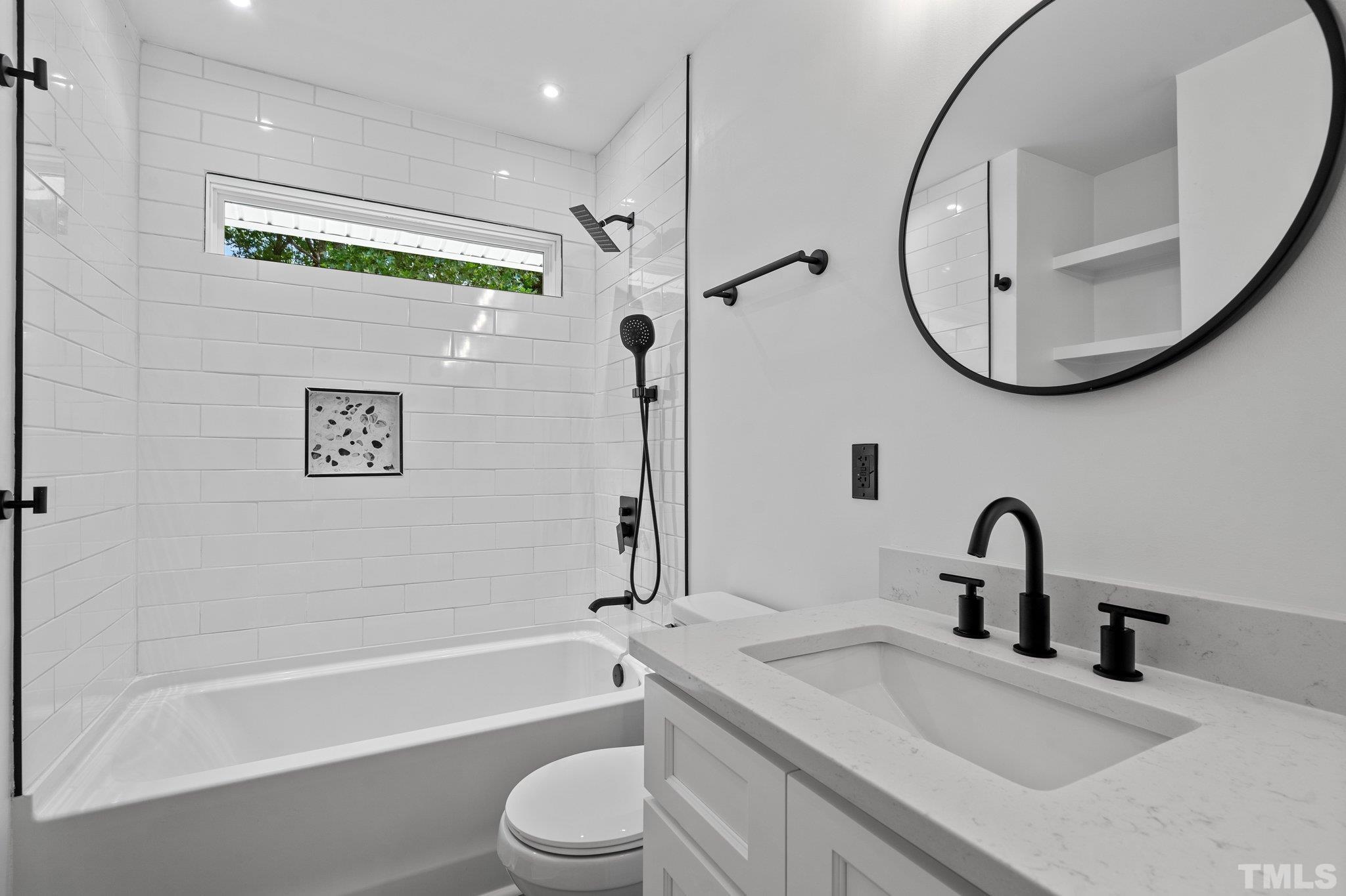 1102 Jerome Road Durham, NC 27713 - Photo 23 of 41 a bathroom with a sink a toilet and a mirror